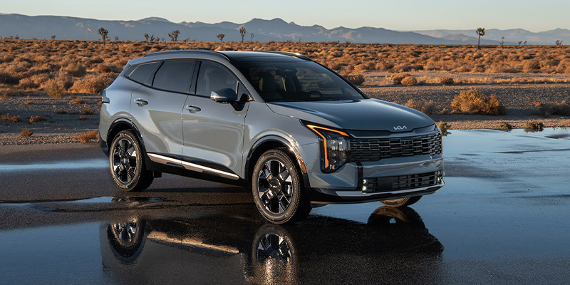 A grey Kia Sportage Hybrid parked off-road